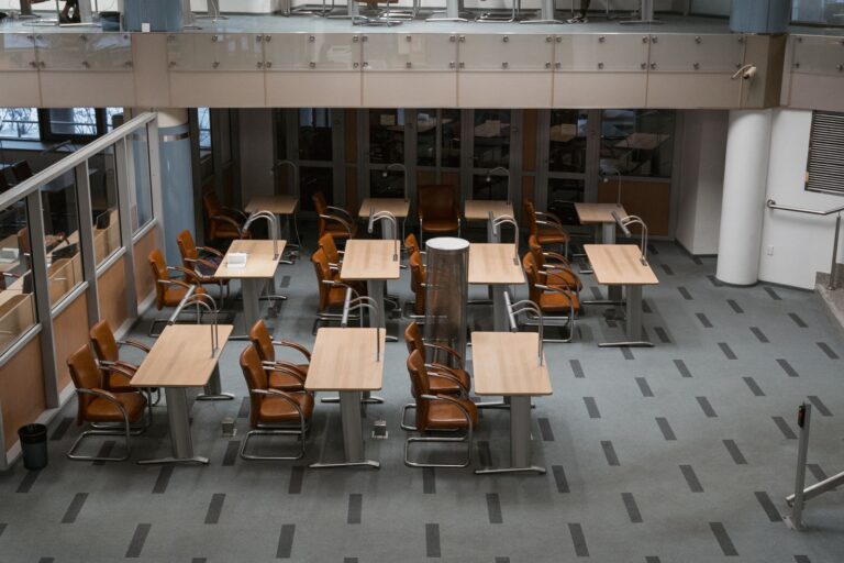 Coworking space with rows of desks and chairs in a modern office