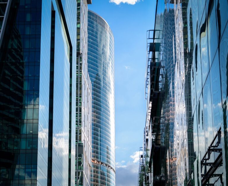 Modern glass office skyscrapers reflecting the sky