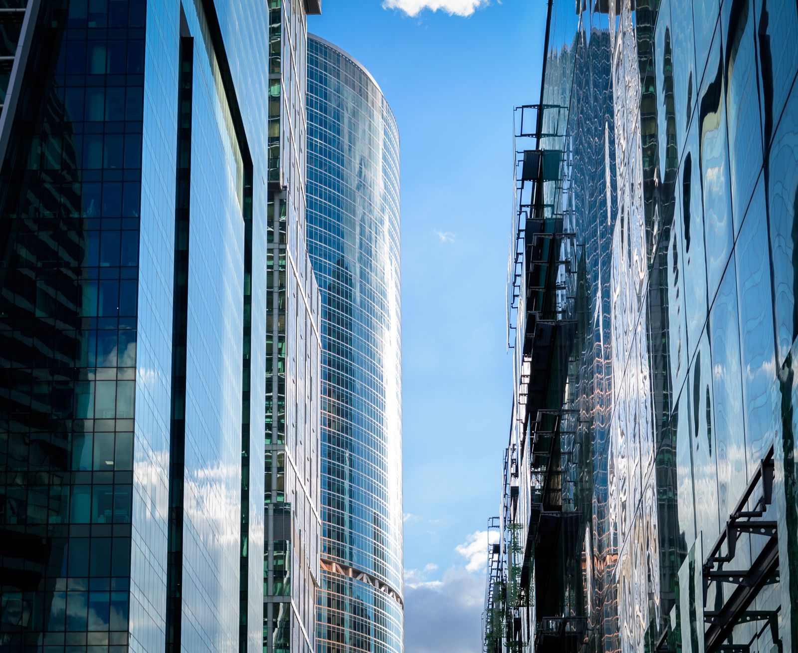 Modern glass office skyscrapers reflecting the sky