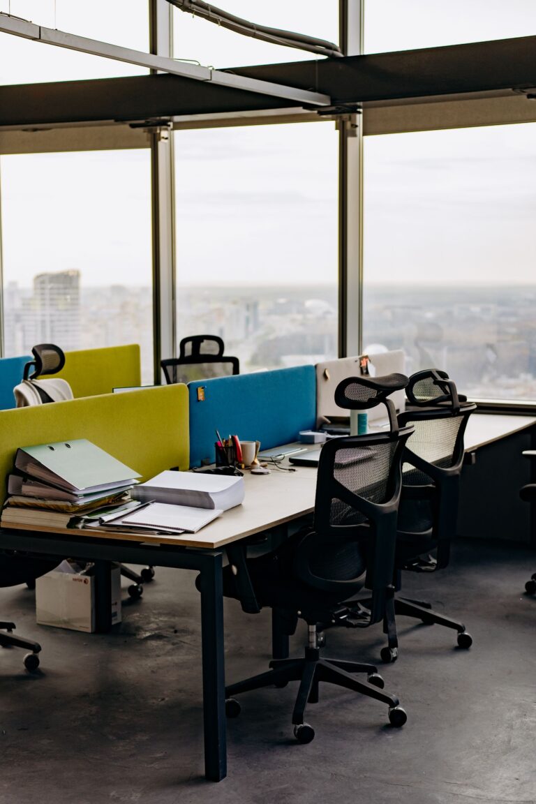 Flexible coworking workspace with desk dividers and city view