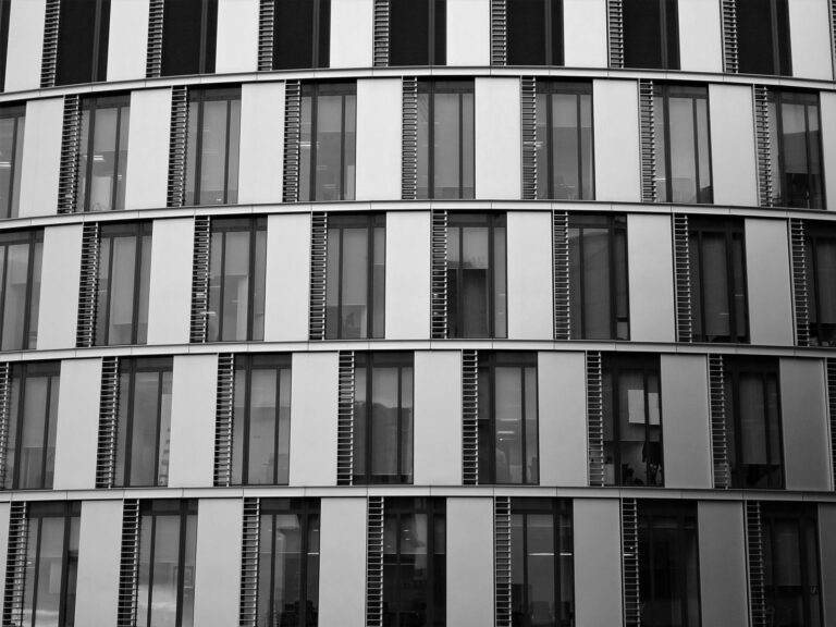 Modern glass office building exterior representing Gurgaon's commercial hub