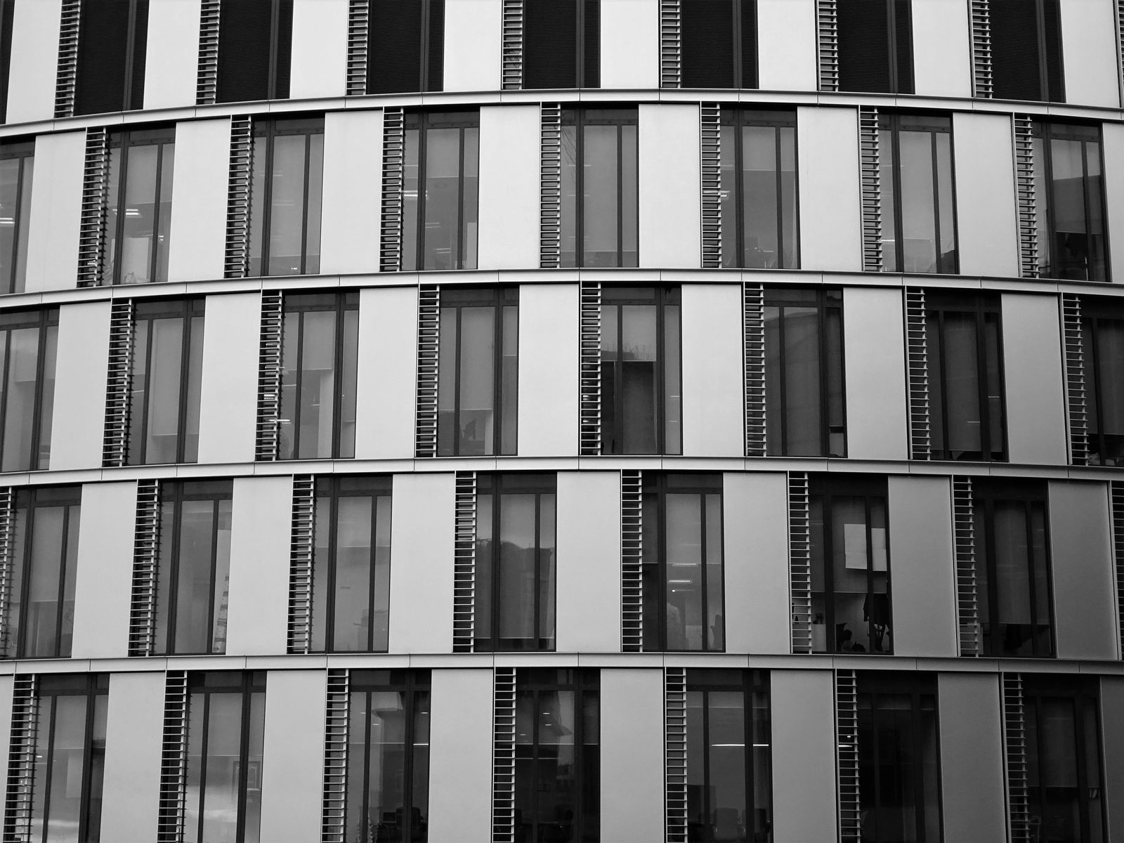 Modern glass office building exterior representing Gurgaon's commercial hub